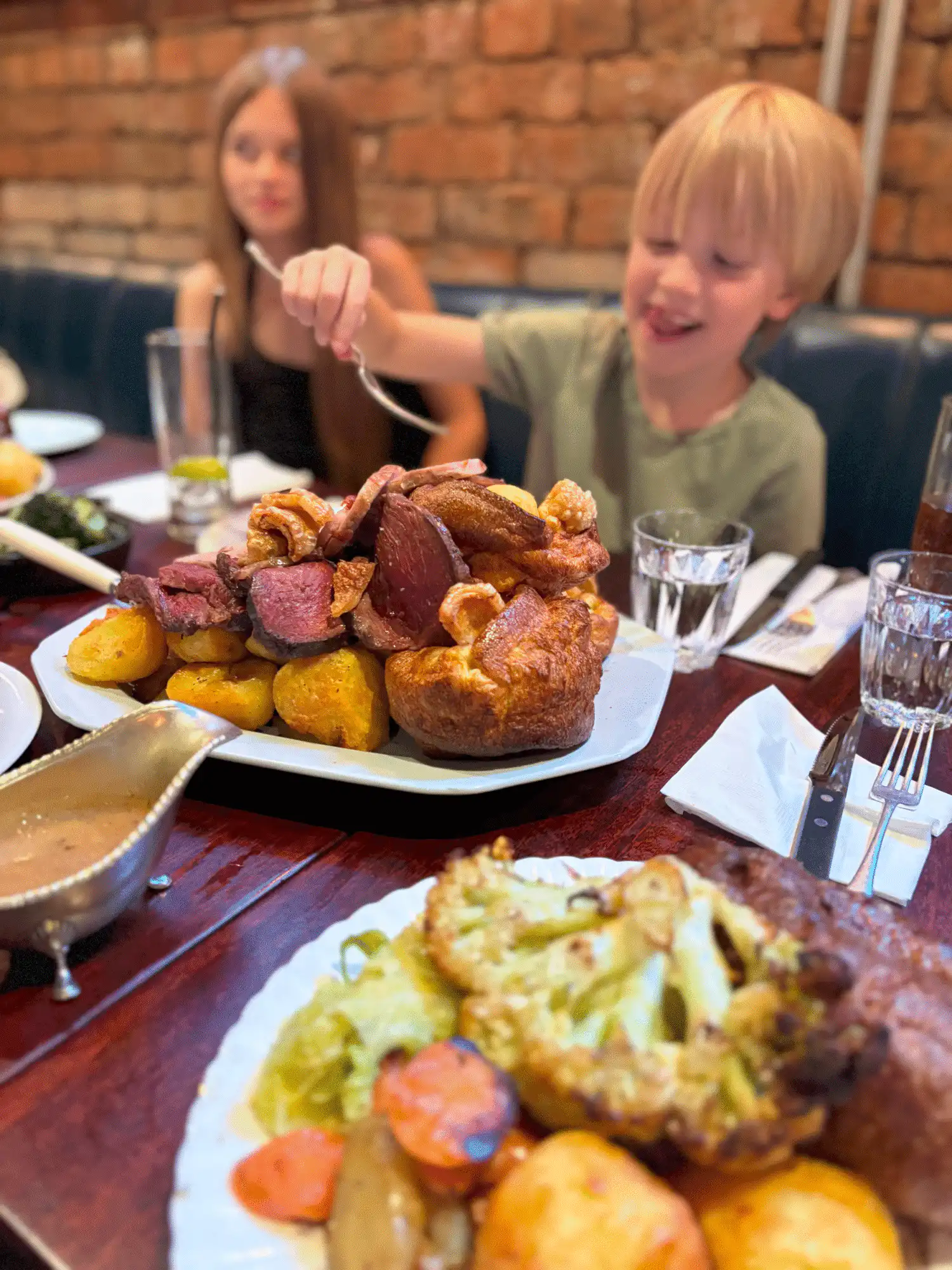 Child enjoying sunday dinner at Blacklock Manchester
