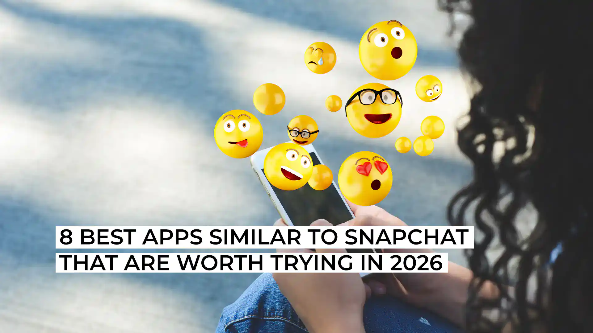 Person holding smartphone with floating emoji icons and reactions.