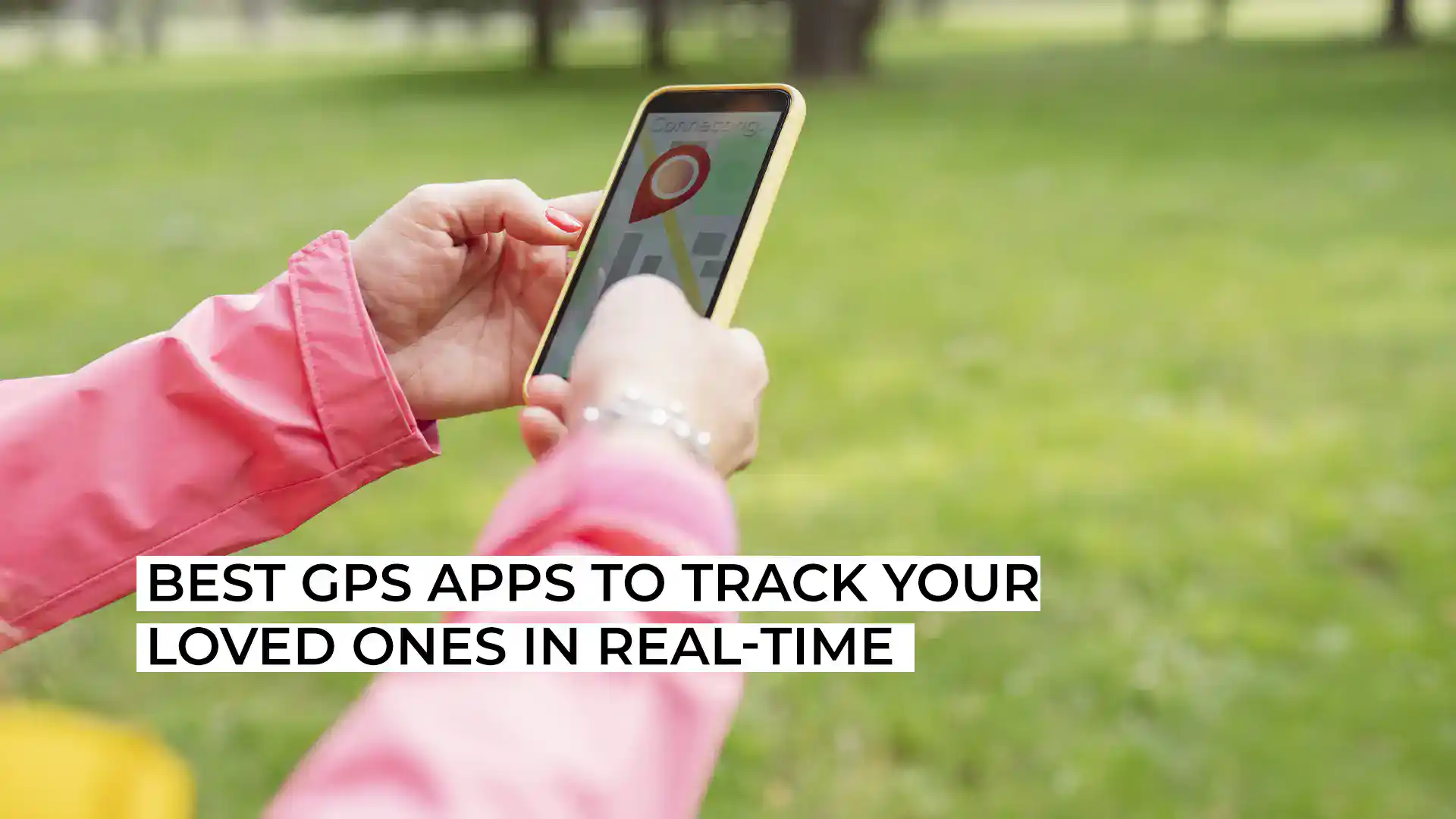 Person using GPS app on smartphone outdoors in park.