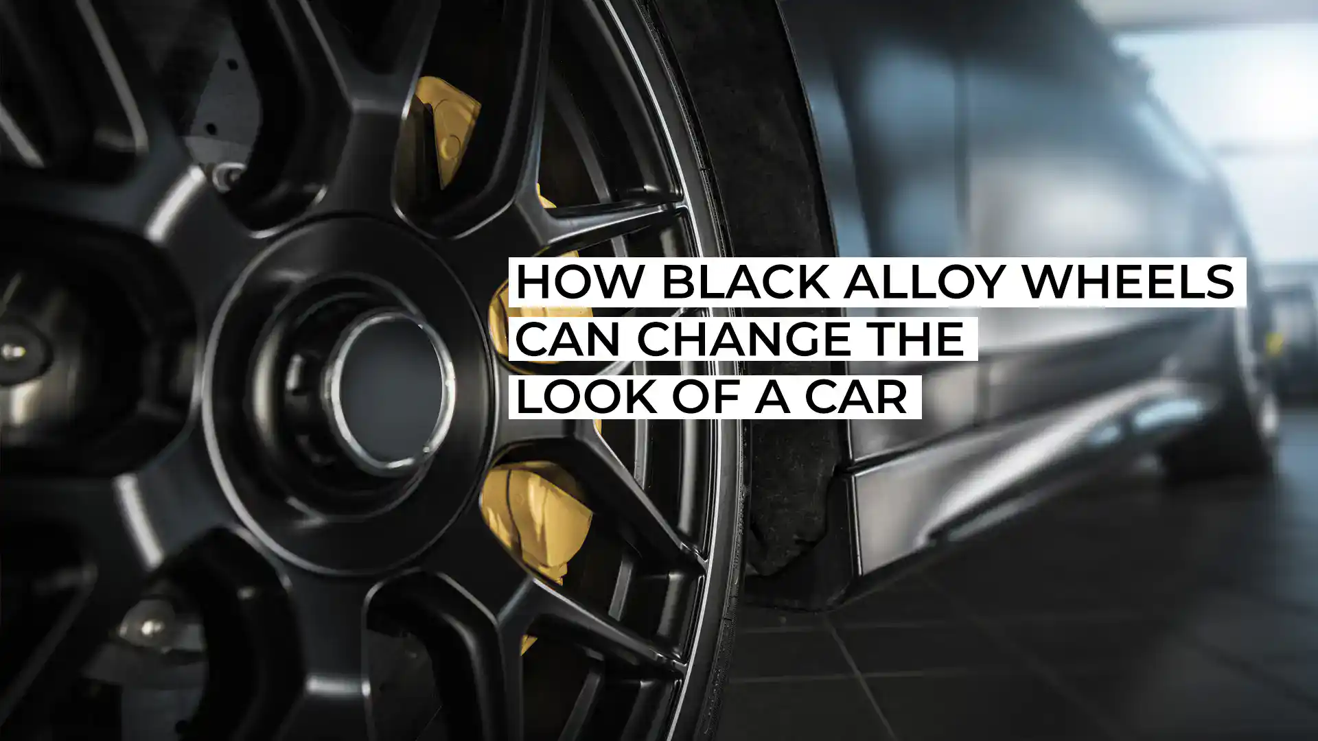 Close-up of black alloy wheels on a sleek car for a modern look.