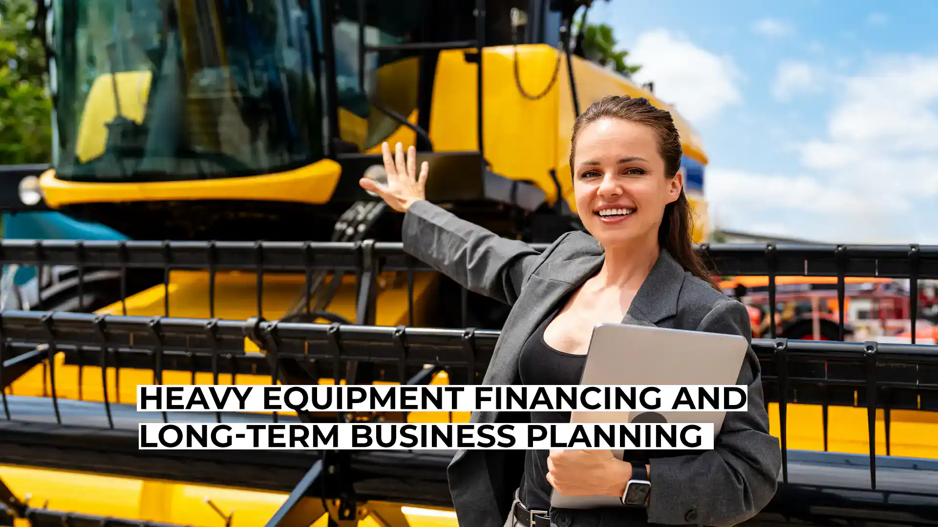 Smiling woman with construction equipment in background.