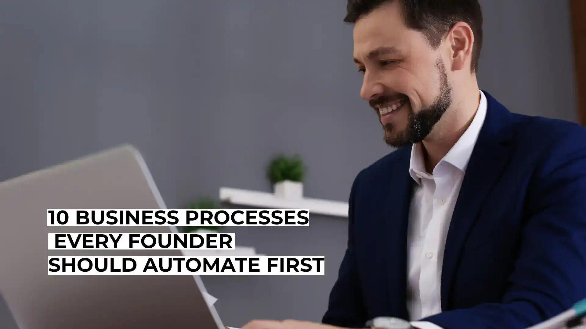 Smiling businessman working on a laptop for business automation.