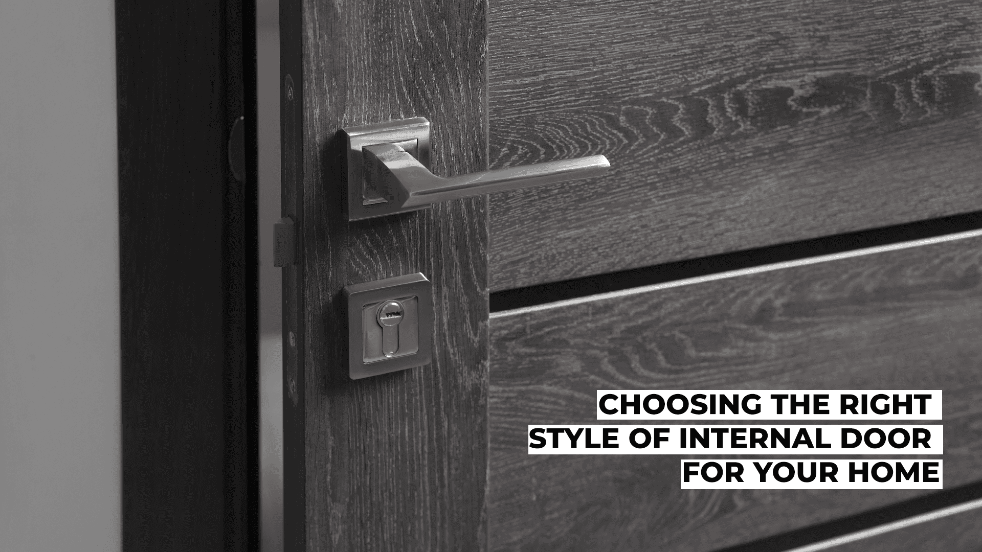 Close-up of a sleek black internal door with a silver handle.