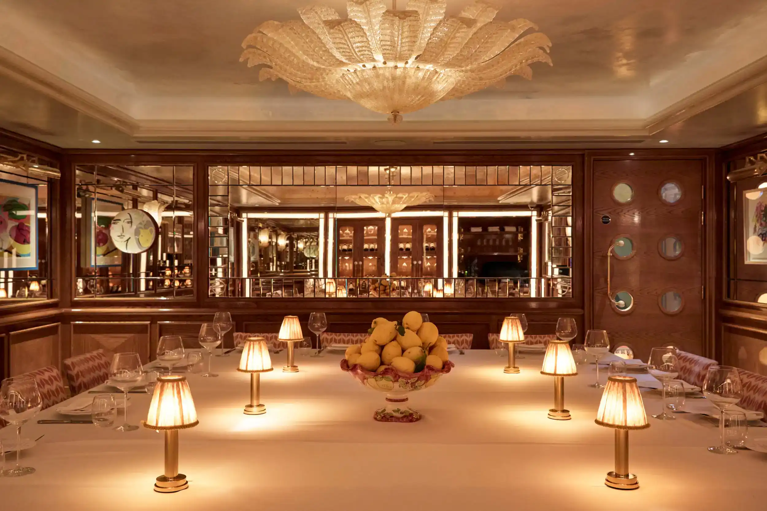 Luxurious Venetian-style dining room with a long table and ambient lighting.