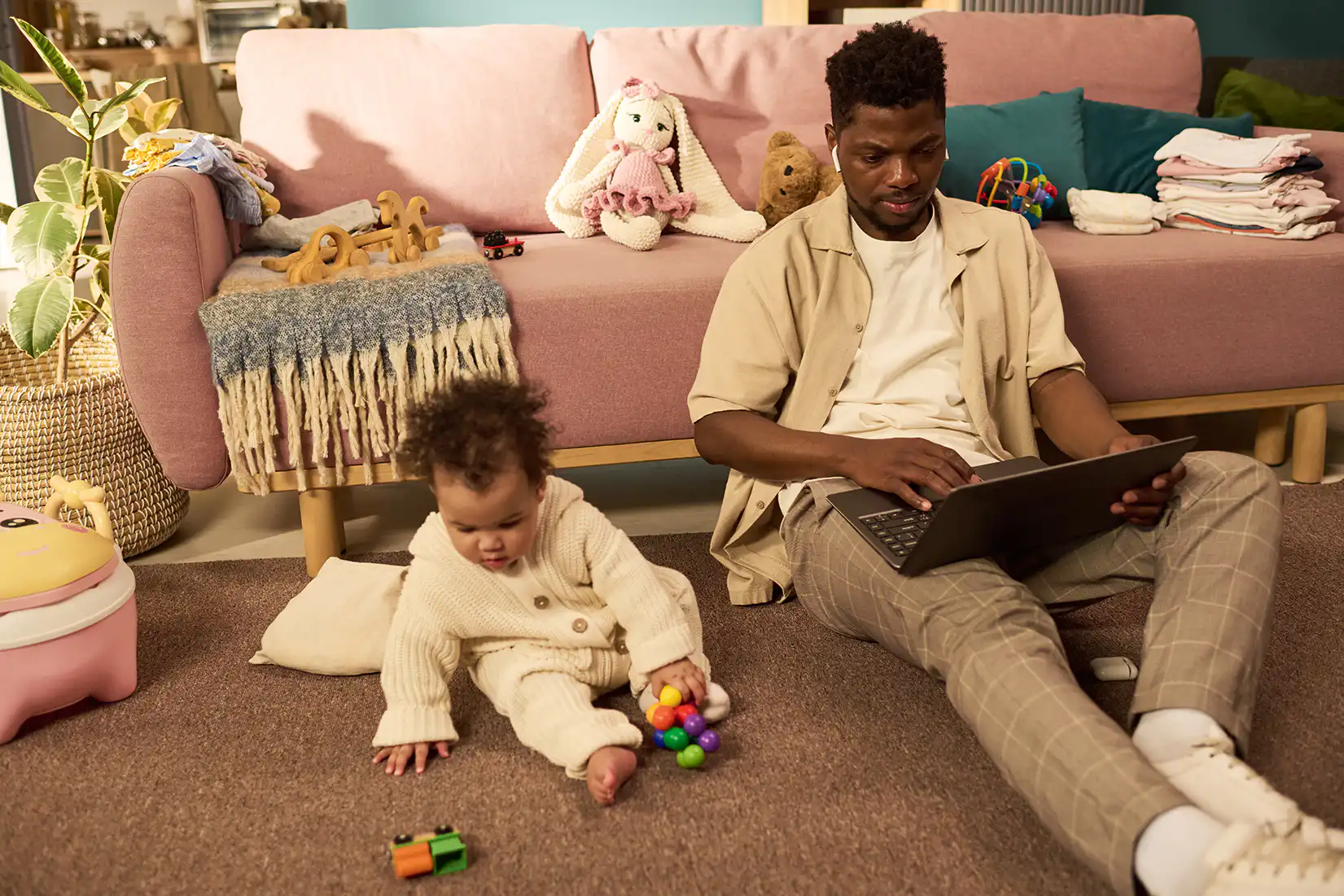 Dad works at home with his infant child
