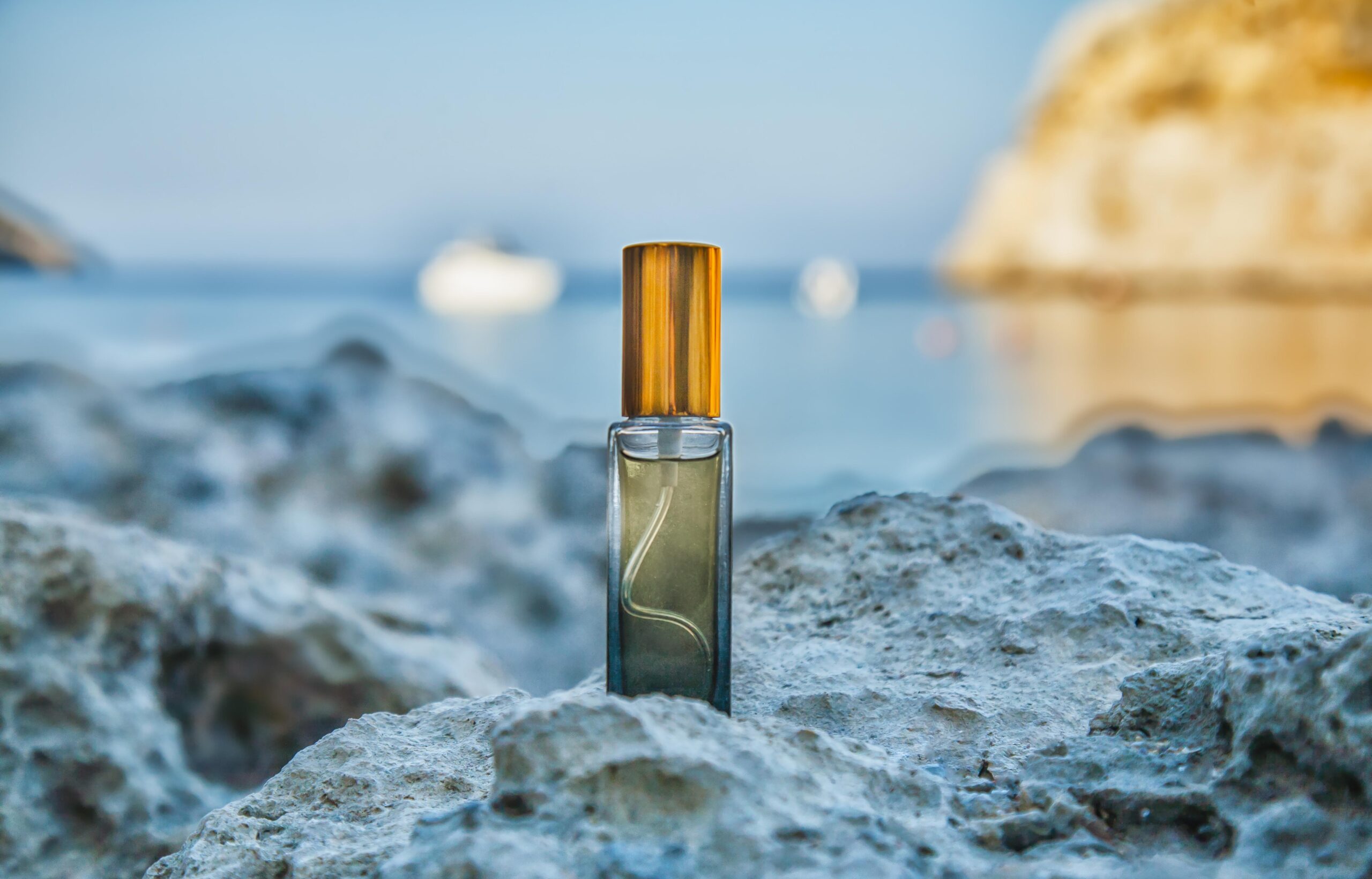 Perfume bottle displayed on rocky shore