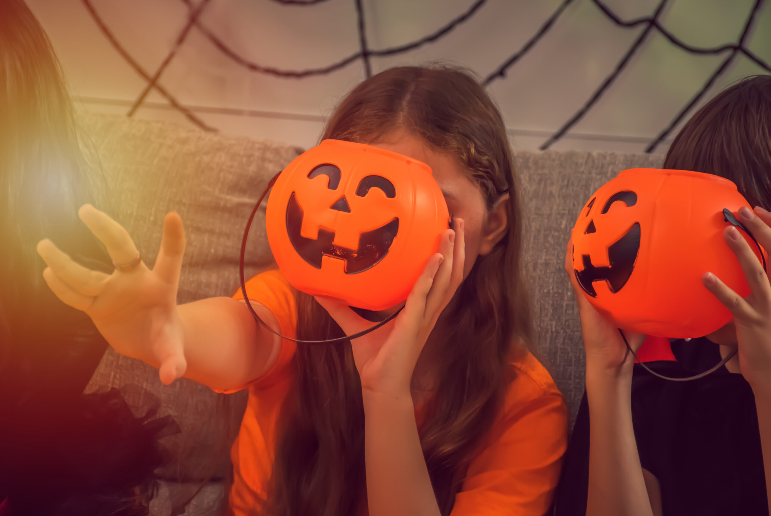 Child celebrating Halloween at home with pumpkin